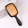 Hollow massage hairbrush with ergonomic handle in a black and orange contrast design - Black Handle + Orange