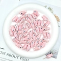 Macro shot of small pink ceramic fish beads for DIY jewelry making and crafting - Light Pink