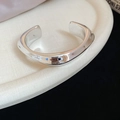 Macro shot of irregular wave-shaped silver cuff bracelet with high-polished finish - Silver Narrow Square