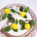 Set of four realistic yellow lemon napkin rings with green leaves and woven vine base - Four Leaf Raffia Lemon Style