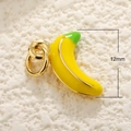 Macro detail of a 12mm yellow banana enamel pendant with gold metal for jewelry making - Banana
