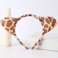 Detailed view of brown and beige giraffe print plush animal ear headband - Sika Deer