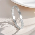 Detailed macro view of the silver titanium steel bracelet with quilted geometric pattern - Quilted Pattern Bangle (Silver)