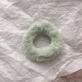 Detail of soft light green plush faux rabbit fur scrunchie with fluffy texture on white base - Light Green