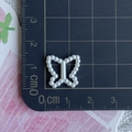 Detailed view of white pearl resin bow craft bead measured with ruler for DIY hair accessories - Butterfly