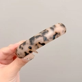 Close-up of tortoise shell resin bracelet with brown and black leopard patterns - Light Tortoise Shell