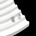 Macro shot of silver minimalist hollow heart stud earrings with petal backings - Hollow Heart