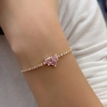 Macro detail of a gold chain bracelet featuring a large pink heart-shaped zircon stone - Heart - Gold