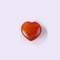 Polished heart-shaped red agate gemstone pendant with a smooth translucent finish - Red Agate