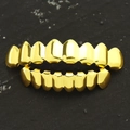 Close-up of gold-plated hip hop grillz set for top and bottom teeth on black background - 16-Piece Set / Top 8 Bottom 8 Gold Set