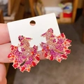 Detailed macro view of goldfish stud earrings with gradient pink rhinestones - Purple-Koi Shape