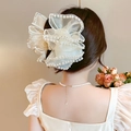 Close-up of oversized mesh bow hair claw clip with pearl trim on a model - Multi-layer Pearl-Creamy White Claw Clip