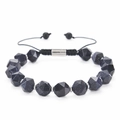 Macro detail of faceted blue goldstone beads and adjustable braided cord on a bracelet - 10MM Faceted Blue Sandstone Bracelet