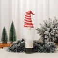 Detailed close-up of Christmas gnome wine bottle cover with red striped knit hat and white beard - Red & White Stripes Style