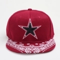 Macro shot of red snapback hat with paisley print brim and five-point star embroidery - Burgundy