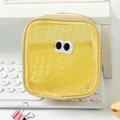 Detailed close-up of yellow mesh storage bag with embroidered big eyes on a desk - 13*7*13cm / Yellow
