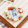 Colorful ceramic beaded bracelet featuring red apple and star charms on display - Peace Apple II (1267-07)