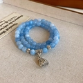 Ice blue multilayer bead bracelet with vintage metal charm on textured fabric - Aquamarine Color Fortune Bag 3-Layer Bracelet