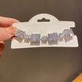 Detailed view of silver bracelet with radiant cut zircons and oval crystals on display card - 37# Bracelet - Silver - Transparent