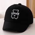 Close-up of black cotton baseball cap with white LOVE bear embroidery and heart detail - 52cm (2-5 Years) / Black