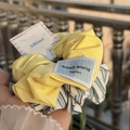 Two-piece hair scrunchie set in bright yellow and blue-white stripes with Alline brand tags - Solid Yellow and Blue-White Stripe Scrunchie Set