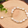 Elegant baroque pearl bracelet with gold bead accents and a vintage spring clasp - Polished Oval Pearl Bracelet