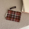 Flat lay of vintage plaid coin purse with zipper on gray carpet background - Orange Red Plaid