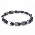 Detailed macro view of 6mm black hematite beads and silver V-shaped metallic spacers - Matte Stone