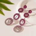 Macro detail of luxury gradient purple rhinestone geometric drop earrings on ceramic - Gradient Pink Purple