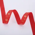 Close-up of red grosgrain ribbon with gold snowflake pattern and ribbed texture - Gold Stamping Red Snowflake (2.5cm Width 5m Length)