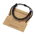 Detail view of leather Morse Code bracelet with metal beads on a kraft paper gift card - Fuck Off