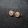 Macro side view of rose gold spiral stud earrings with elegant polished metal texture - Geometric Spiral Rose Gold