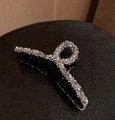 Close-up of black hair claw clip featuring elegant white pearls and silver rhinestones - Black