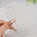 Detail view of champagne gold star and moon nail stickers on model hand, model C7303 - C7303 / Champagne Gold