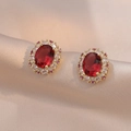 Exquisite gold-plated earrings featuring a red oval gemstone with a halo of white zircons - Oval Red Stone Surround Style (E0597)