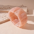 Macro detail of rectangle acrylic bracelet showing marble pink and orange texture - Pink