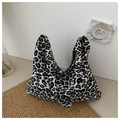 Detail of trendy leopard print canvas tote bag with spacious interior for daily commute - Black