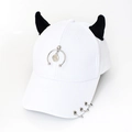 Detail of white baseball cap featuring black horns, silver rings, and a metal smiley pendant - Half Ring Smiley White
