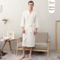 Men's white waffle knit bathrobe with V-neck and waist tie in a cozy home setting - White (Men's)