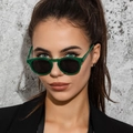 Retro small frame sunglasses with green frame and black lenses on female model - Green