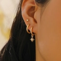 Golden star stud and hoop earring set for multiple piercings worn by a model - Star Gold Style (H-169)