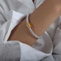 Silver twisted cable bracelet with gold clasp and light blue marquise stone on wrist - Sea Blue Rhinestone