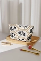 Detailed macro view of the French vintage linen makeup bag with floral embroidery texture - Black Leaf Large