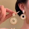 Detail of flower tassel earring with golden metal and resin rectangle in close-up - Square Gemstone Wrapped Coil Style / 5# 925 Sterling Silver Earring Post - White
