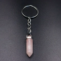Detail view of a hexagonal rose quartz crystal point pendant attached to a silver keychain - Rose Quartz