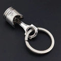 Silver metal car piston keychain accessory with polished finish on black background - New Silver Piston