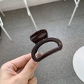 Close-up of glossy chocolate brown hair claw clip with smooth thick resin finish - Chocolate