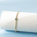 Détail macro du bracelet en acier inoxydable 18K avec zircon bleu et accents colorés - Décembre / Zirconia Bleu