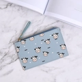 Slim light blue cow print wallet with zipper closure and wrist strap on marble surface - Blue Cow Print