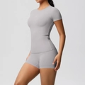 Side view of grey high-stretch yoga set featuring slim fit T-shirt and high waist shorts - S / Top And Bottom / Frost Grey